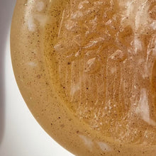 Charger l&#39;image dans la galerie, Extreme closeup of glycerin face soap with an embossed tree design and embedded brown specks of rhassoul clay that can be seen.
